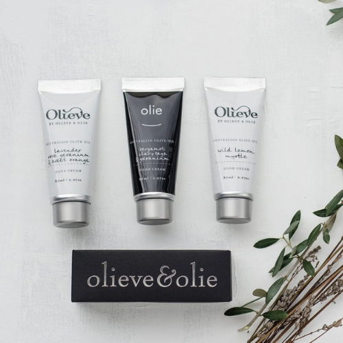 Three skincare products from Olieve & Olie on a light background with a brand card.