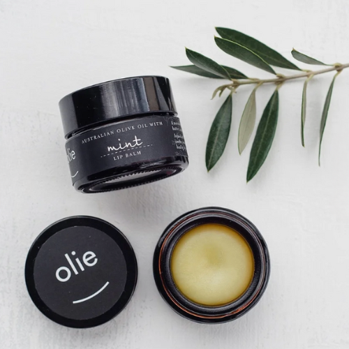 Lip balm jar with 'olie' branding on a light background