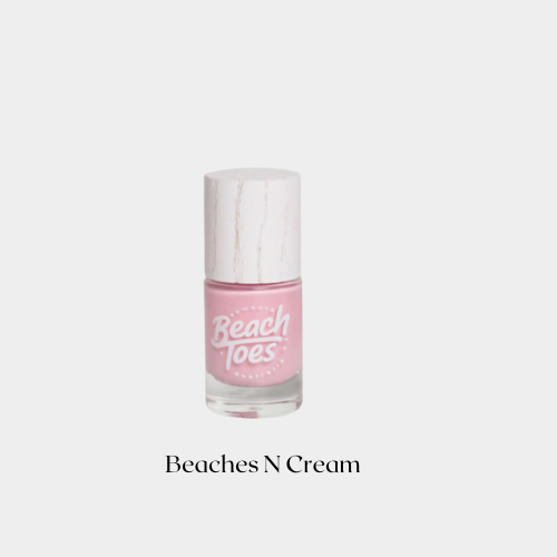 Pink nail polish bottle with 'Beaches N Cream' text on a white background