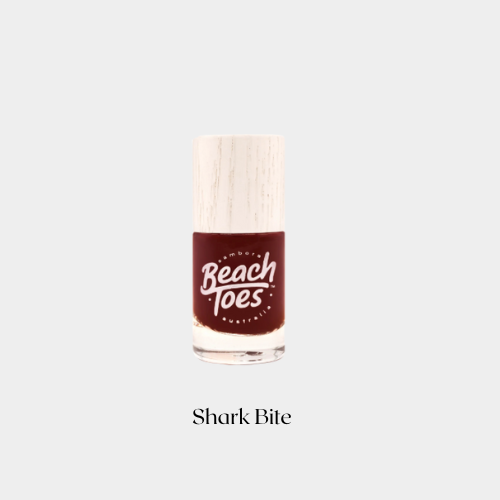 Nail polish bottle with 'Beach Toes' branding on a light gray background