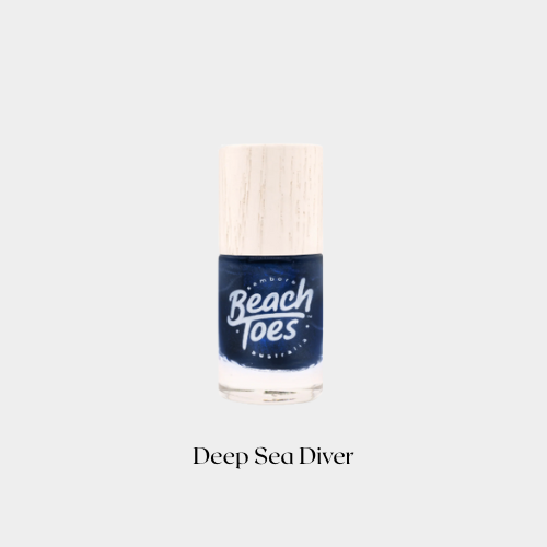 Nail polish bottle labeled 'Beach Toes' with 'Deep Sea Diver' color on a light gray background