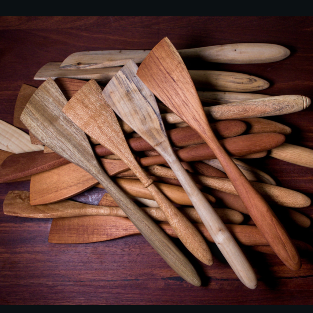 Stack of wooden spatulas on a wooden surface in silky oak, red cedar and camphor laurel