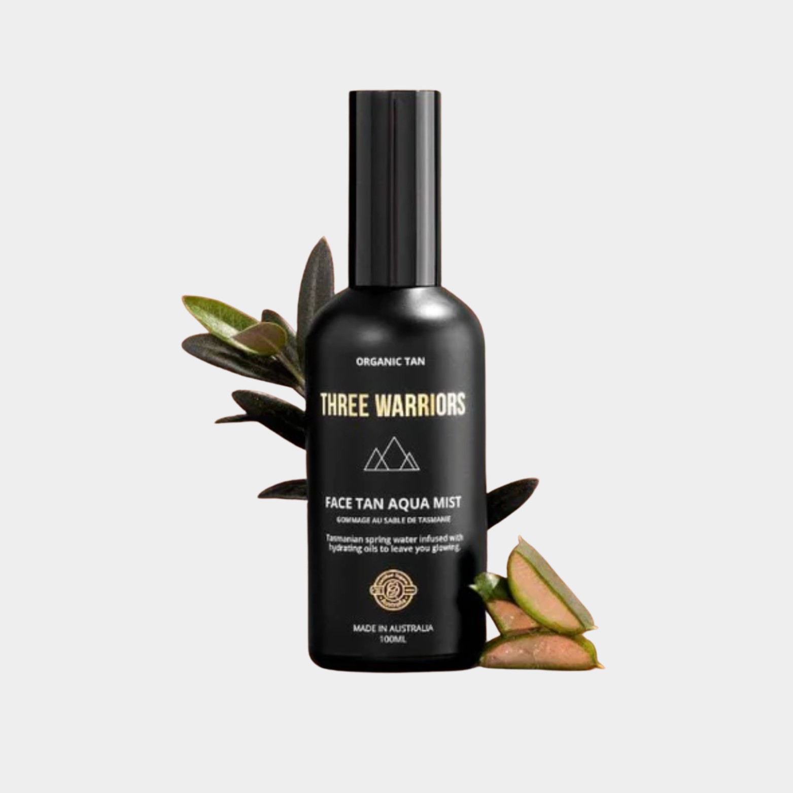 Three Warriors face tan aqua mist bottle with leaves on a light gray background